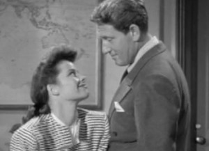 Hepburn flirting in her office after her male secretary ushers in her crush (Spencer Tracy)